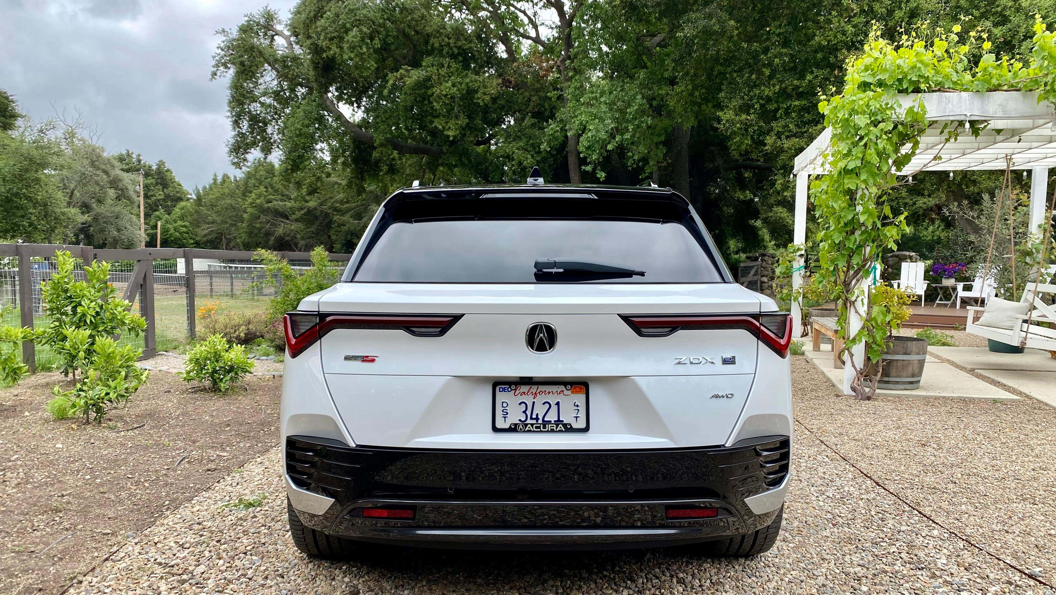 A straight up rear shot of a white ZDX Type S in a garden
